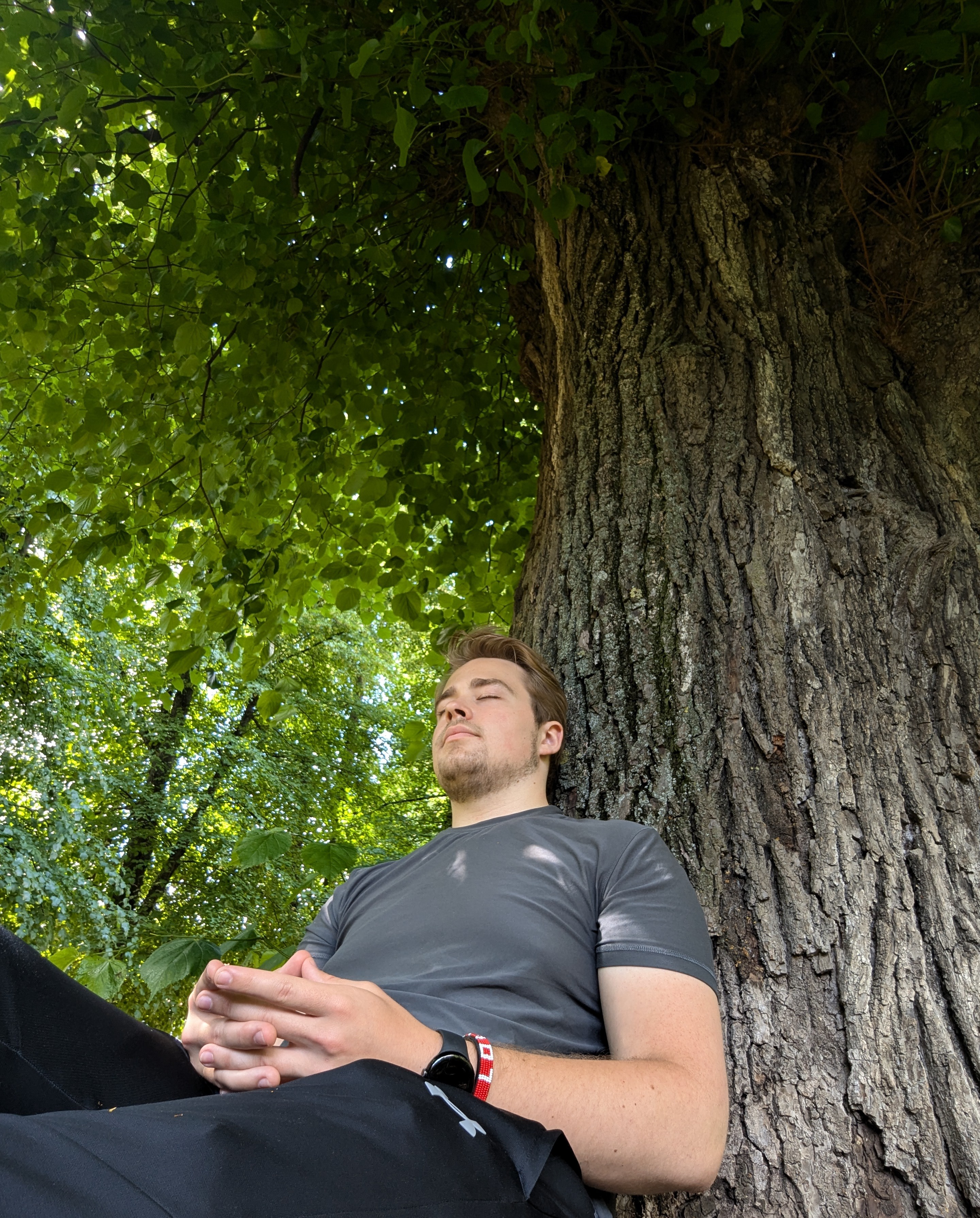 James resting against a lime tree